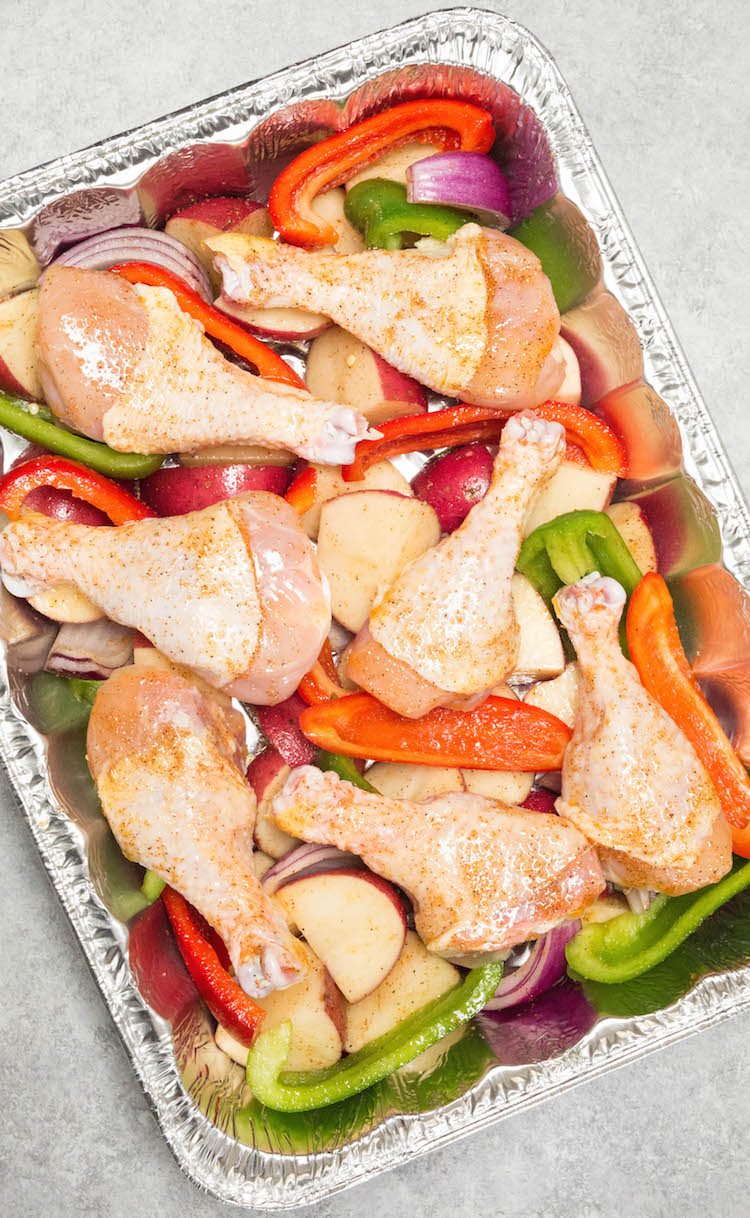 Freezer meal recipe with roasted cajun chicken, bell peppers, onions, and potatoes