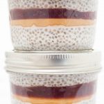 Two jars of peanut butter & jelly chia seed pudding stacked on top of each other