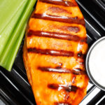 Close up overhead look at the grilled chicken breast covered in orange buffalo sauce